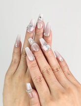 Model wearing Dolce Peach Singapore press on nails in glossy pink coffin shape with silver chain accents by naillover